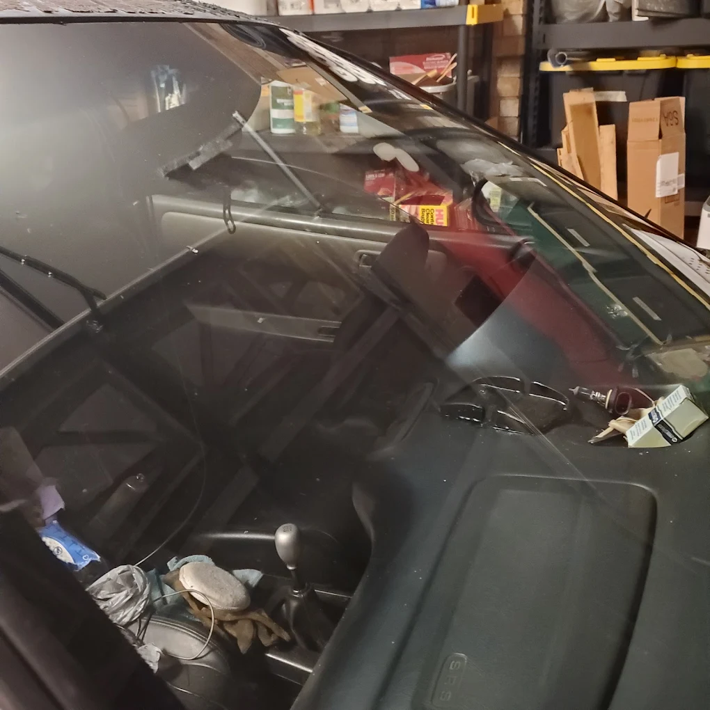 Windshield installation in progress at the Dent Society shop